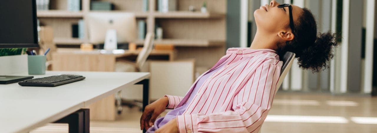 A woman sleeping at her desk